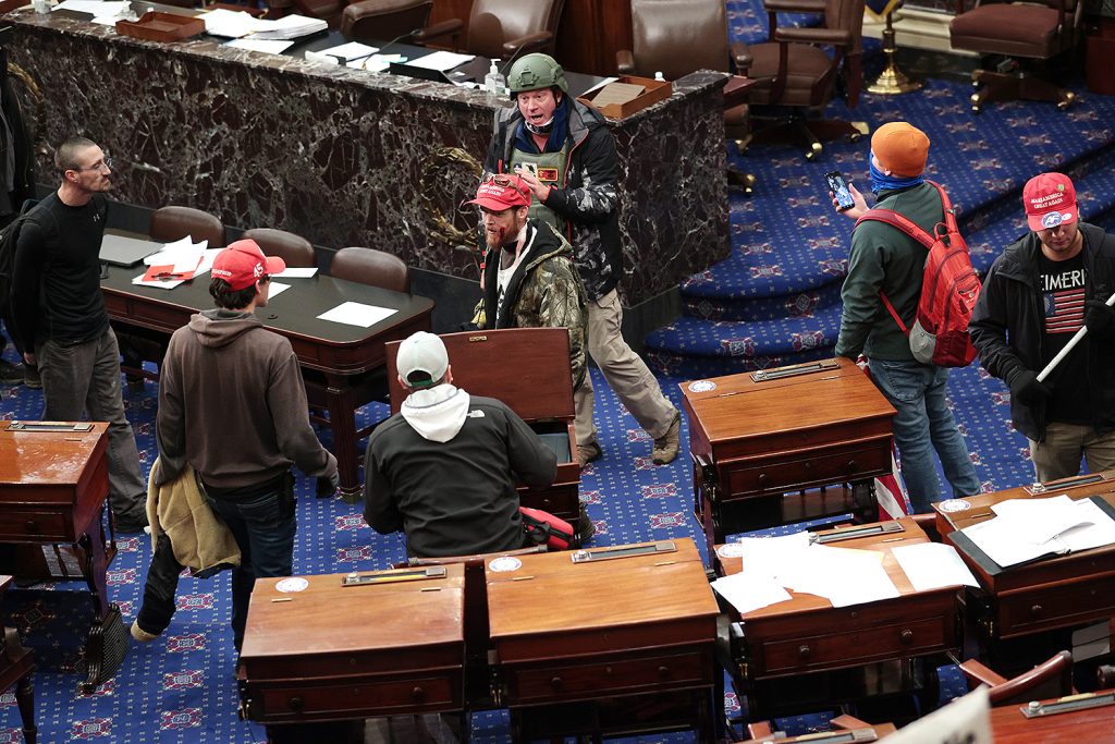 ASHINGTON, DC - JANUARY 06: Protesters enter the Senate Chamber on January 06, 2021 in