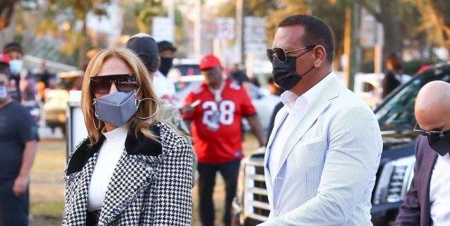 J.Lo Wore a Sweeping Houndstooth Coat and Tiny Louis Vuitton Crop Top to the Super Bowl