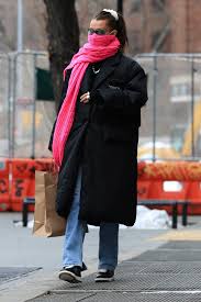 Bella Hadid wore a bright pink scarf over her face mask