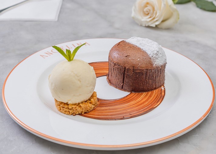 Made with a rich dark chocolate fondant, chocolate ganache sauce served with almond crumble and vanilla gelato.
